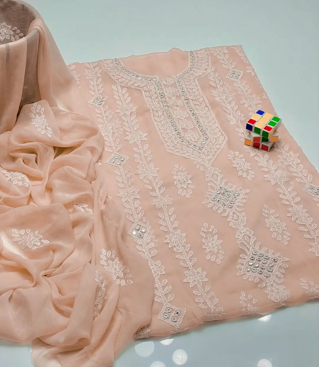 Sheesha mirror work and chikankari embroidery detail on peach chiffon shirt