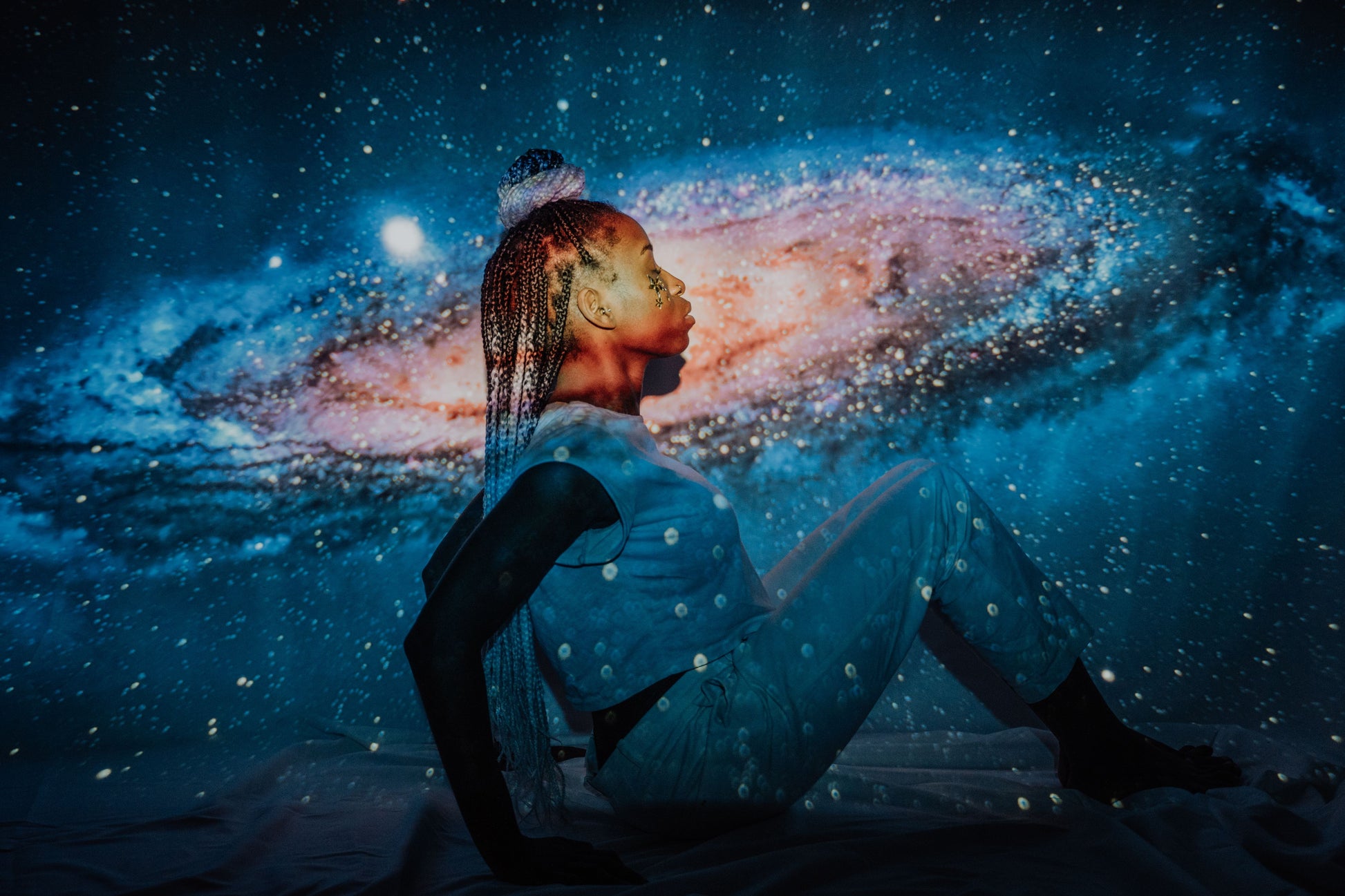 Galaxy light projection effect in a cozy bedroom setting