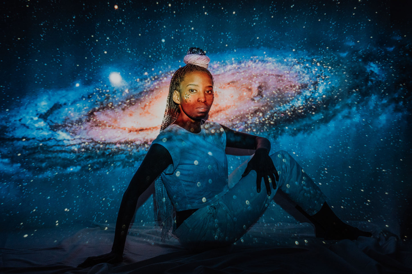 Cosmic galaxy projection glowing across the room at night