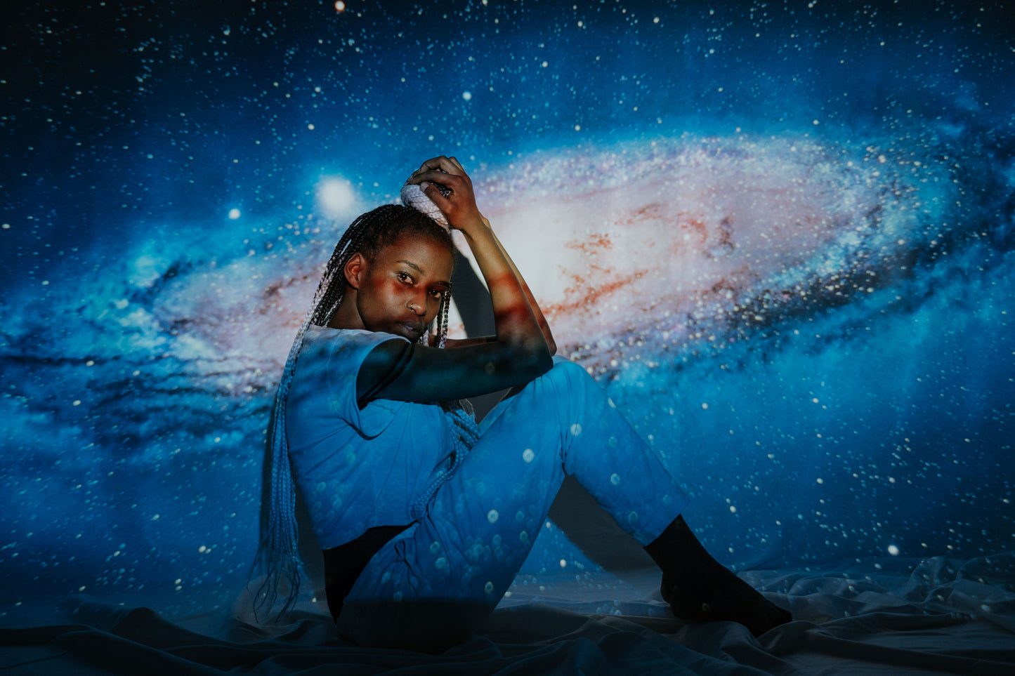 Galaxy projector casting cosmic light across a dark room